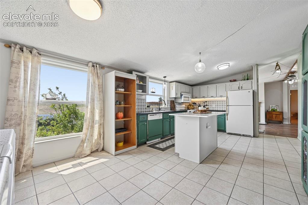Image 23 of 49: Bright and efficient Kitchen with beautiful tile floors!