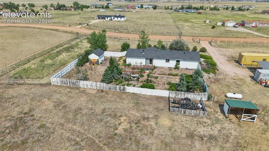 Image 37 of 49: Back yard offers Deck, Pergola, Double Gate Drive Thru-Perfect for RV/Boat