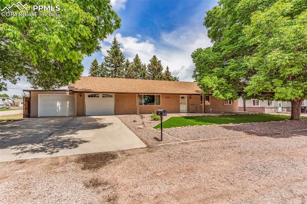 Image 1 of 42: Ranch-style house with driveway, a garage, and stucco siding