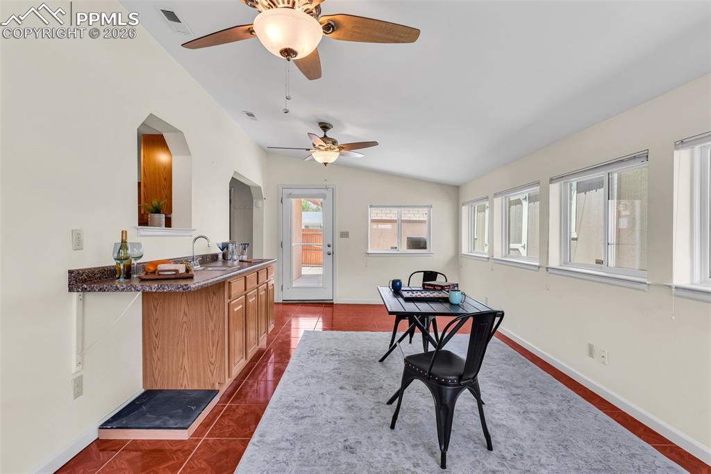 Image 18 of 42: Dining area featuring lofted ceiling, ceiling fan, arched walkways, baseboa