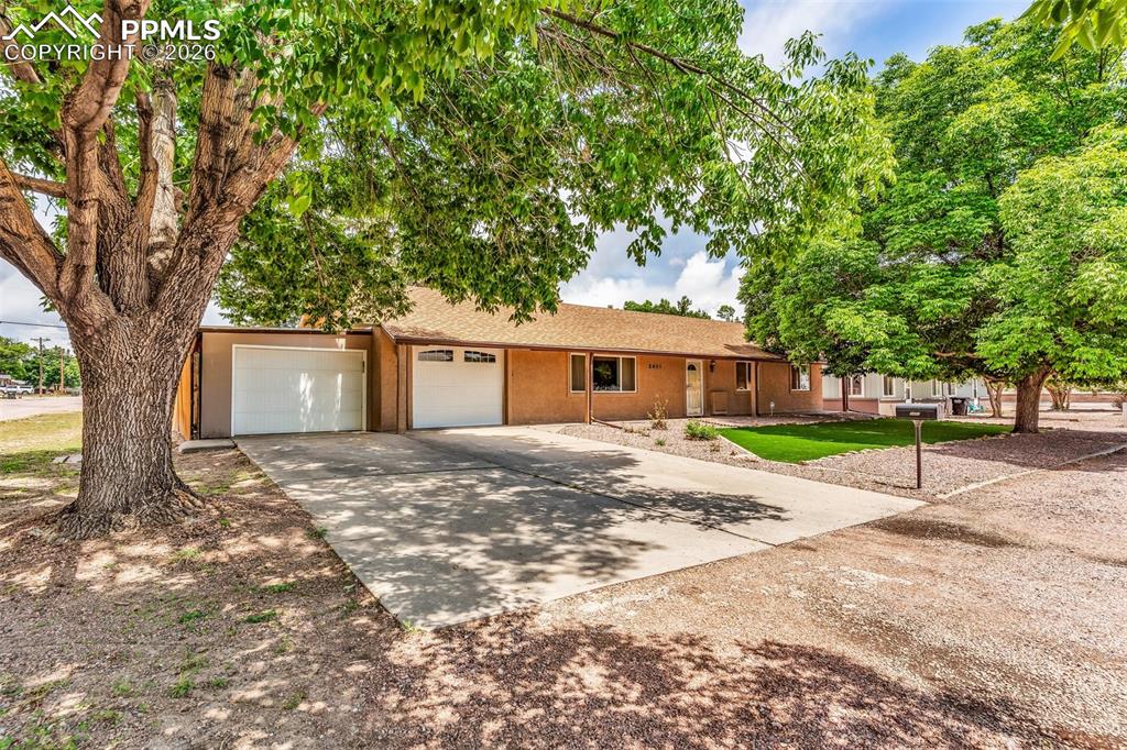 Image 2 of 42: View of front facade featuring stucco siding, concrete driveway, and a gara