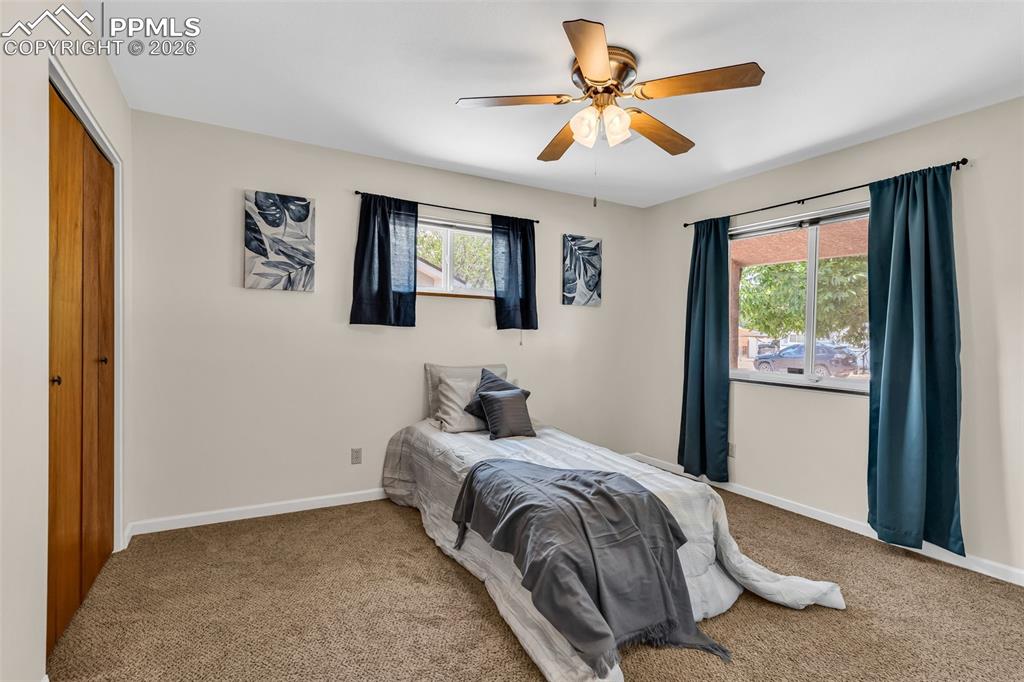 Image 21 of 42: Bedroom featuring carpet, baseboards, a closet, and ceiling fan