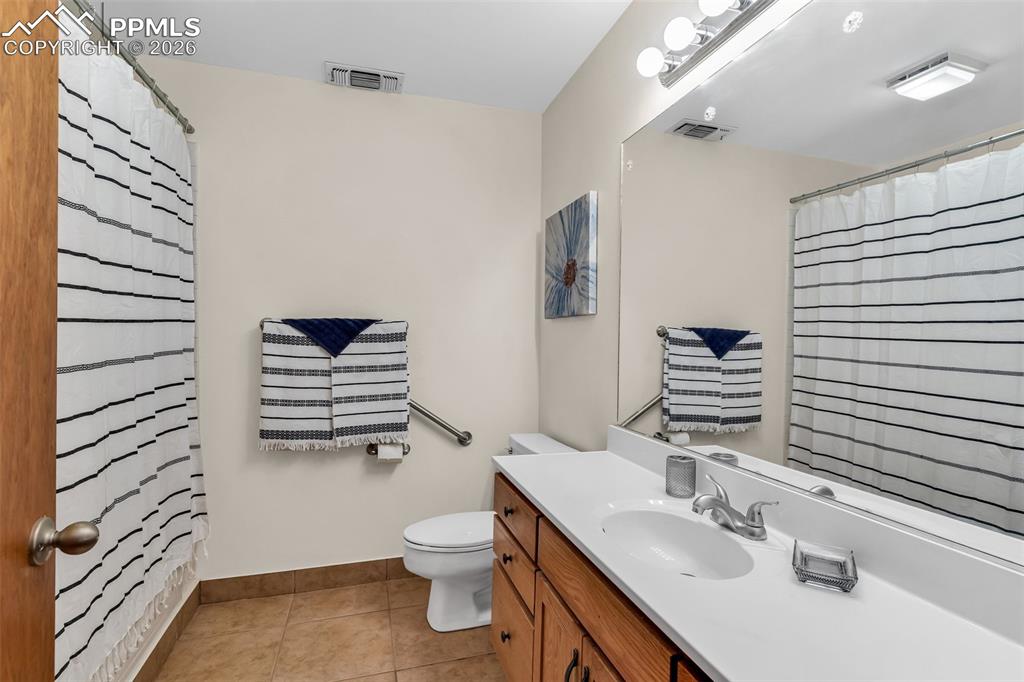 Image 22 of 42: Bathroom featuring vanity, toilet, tile patterned floors, baseboards, and c
