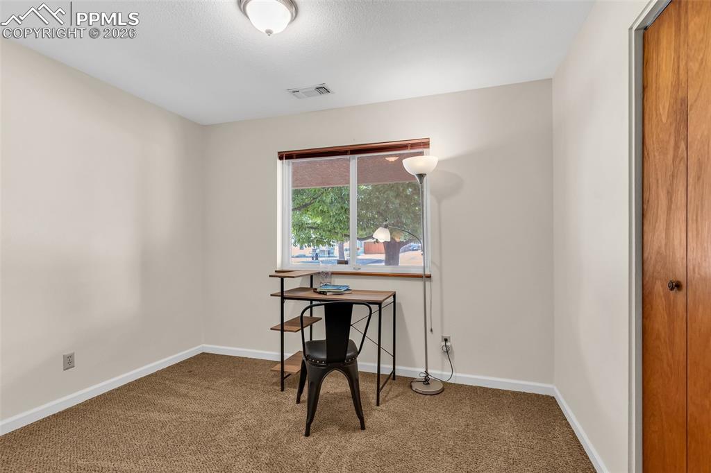 Image 23 of 42: Office space with carpet flooring and baseboards