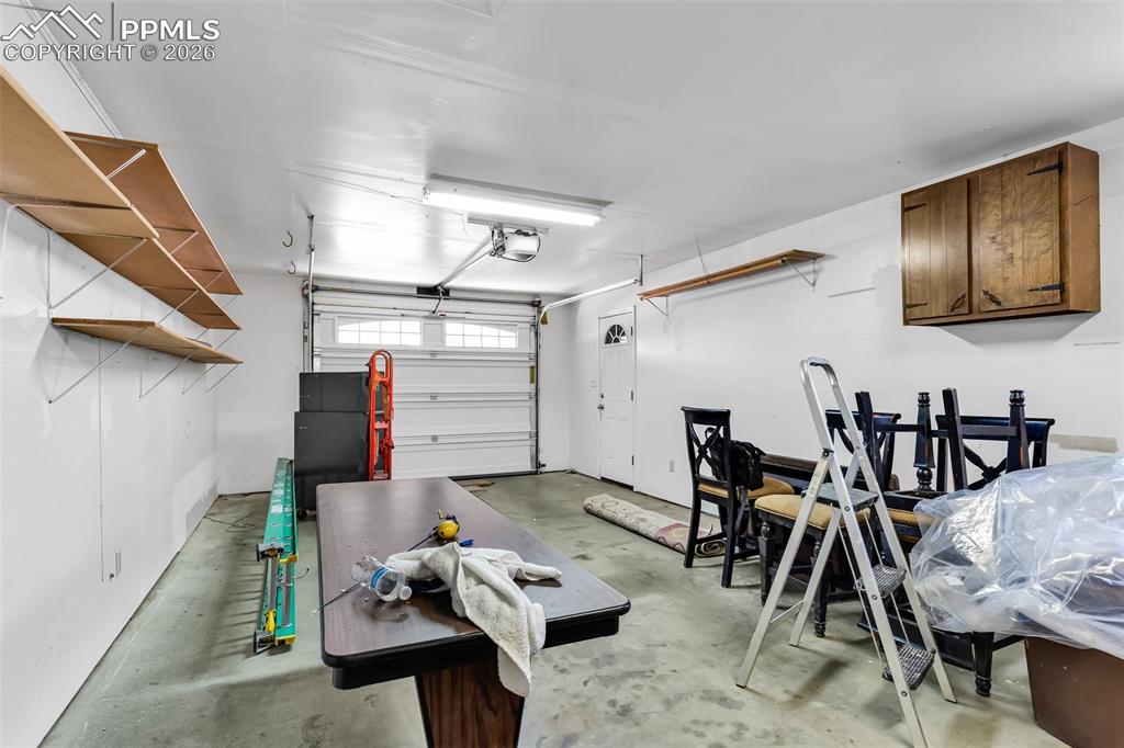 Image 33 of 42: Garage featuring a garage door opener