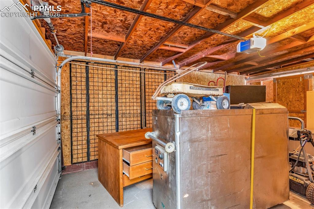Image 35 of 42: Garage featuring a garage door opener