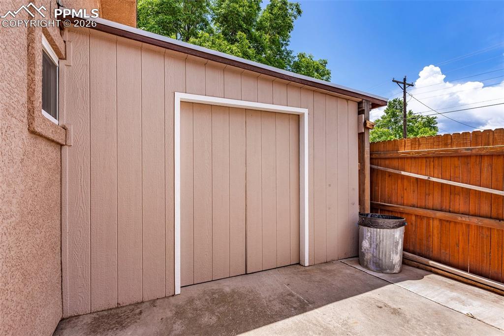 Image 36 of 42: Garage featuring a storage unit