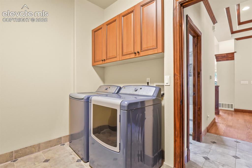 Image 16 of 33: Laundry/mud room located right off the garage