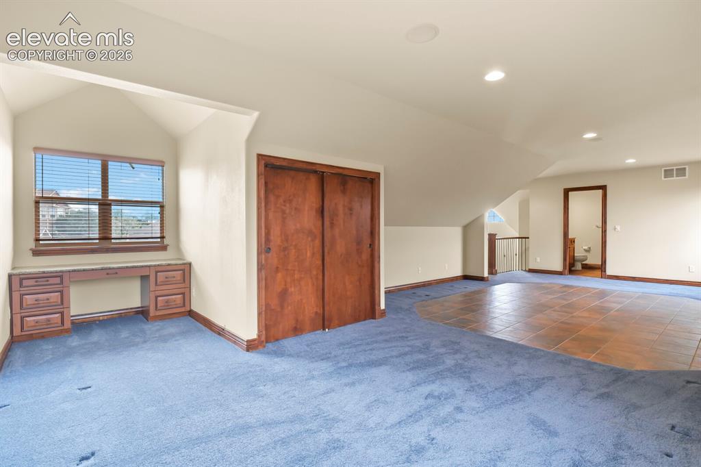 Image 22 of 33: Includes built-in desk area and closet with attached full bathroom