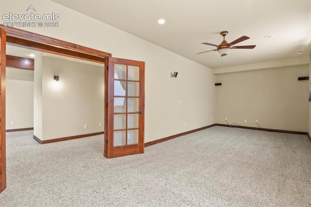 Image 26 of 33: Movie theater room with surround sound, and French doors
