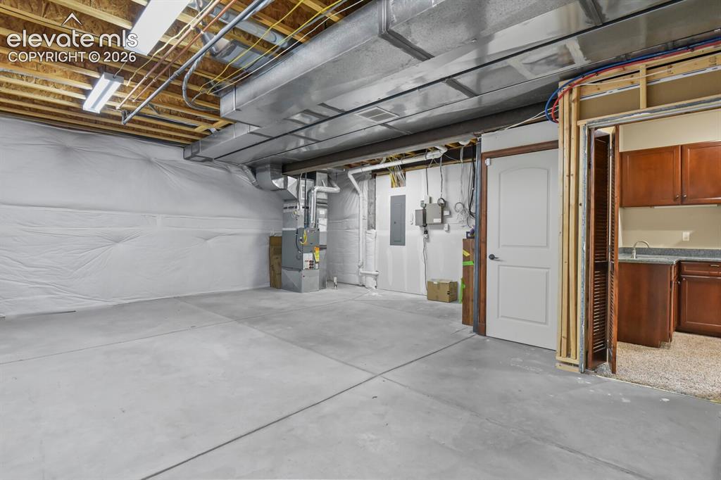 Image 29 of 33: Large lower level storage space with built-in safe could easily be finished