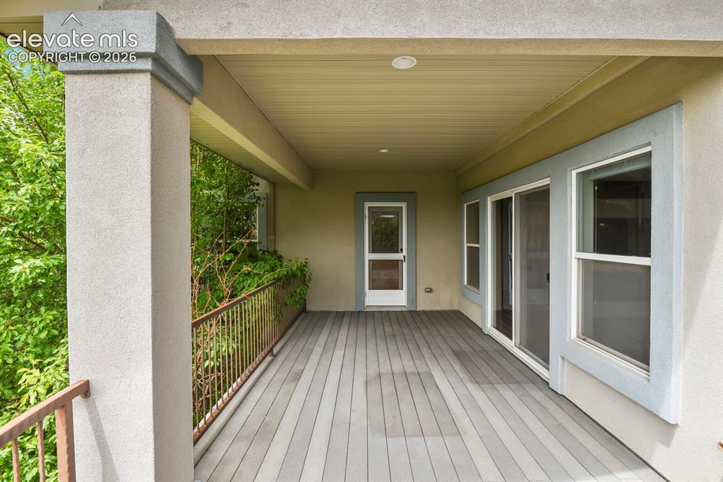 Image 30 of 33: Upper level composite decking with iron railing