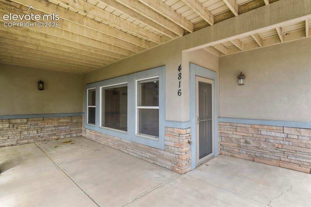Image 31 of 33: Lower-level covered deck and private entrance