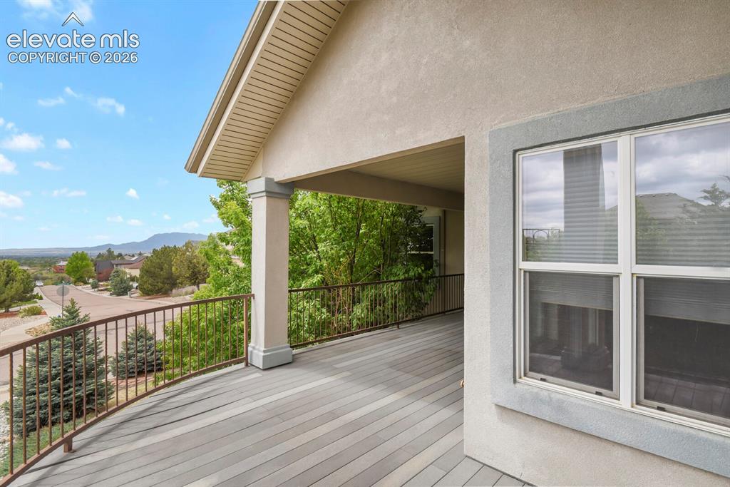 Image 32 of 33: Upper level composite decking with iron railing in those beautiful endless