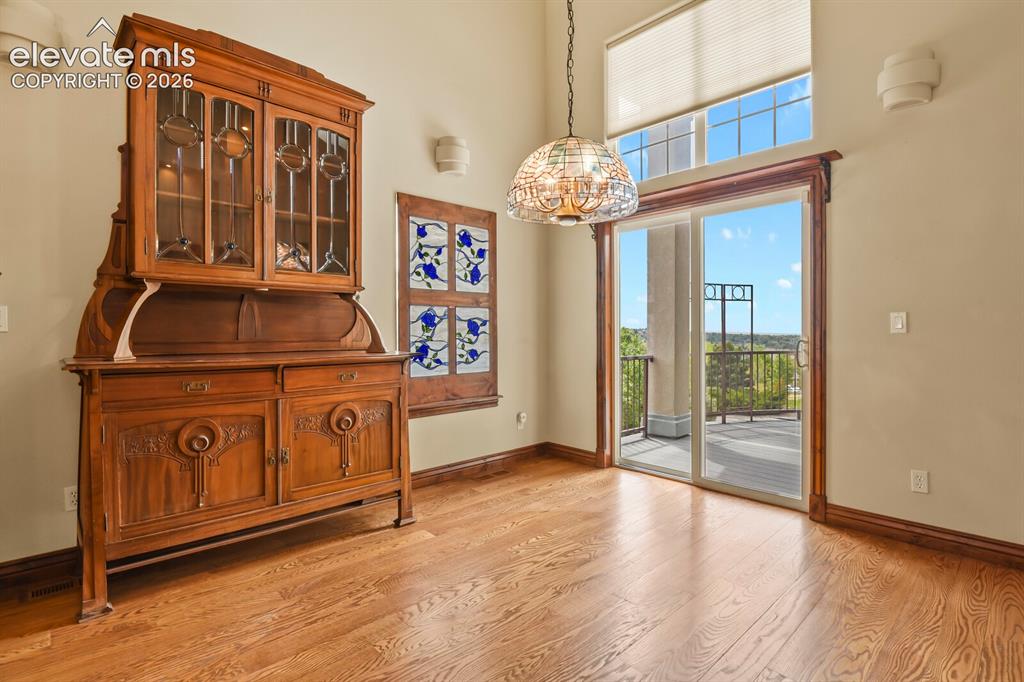 Image 8 of 33: Dining nook includes custom stained glass window and antique curio with wal