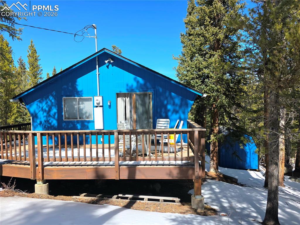 Image 22 of 40: Back deck wraps around to the front entry on the upper level