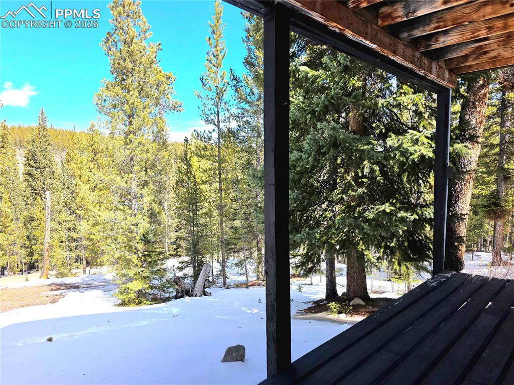 Image 34 of 40: Front deck on lower level of home with entry to lower level