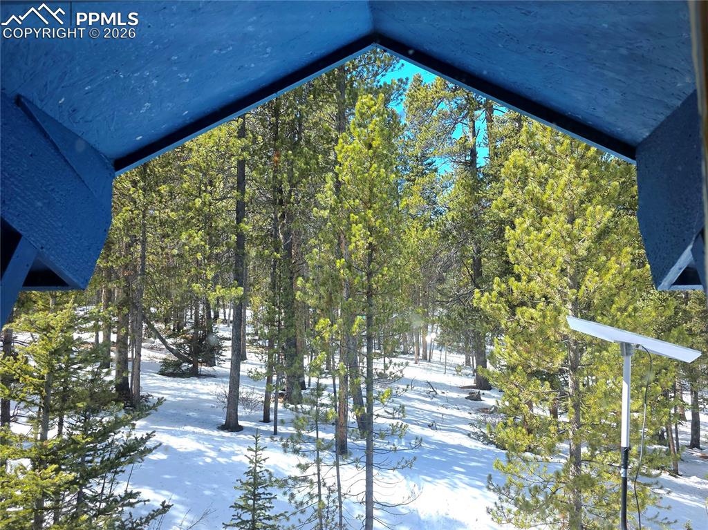 Image 6 of 40: View from the upper level entry door looking out. Winter wonderland in the 