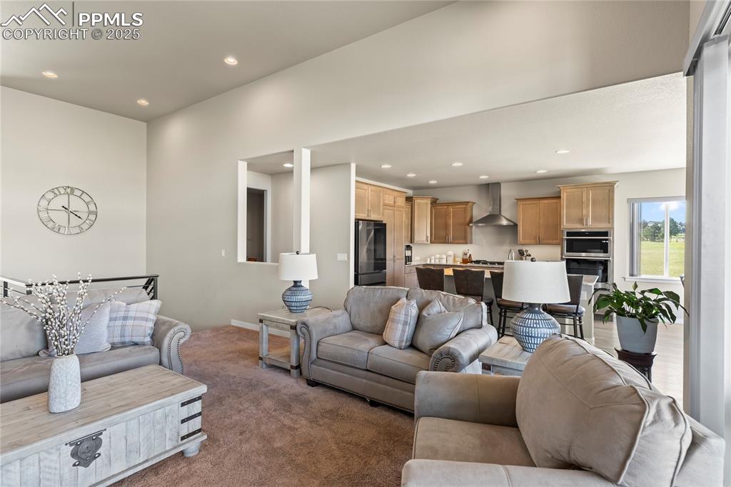 Image 13 of 50: Living area with carpet and recessed lighting