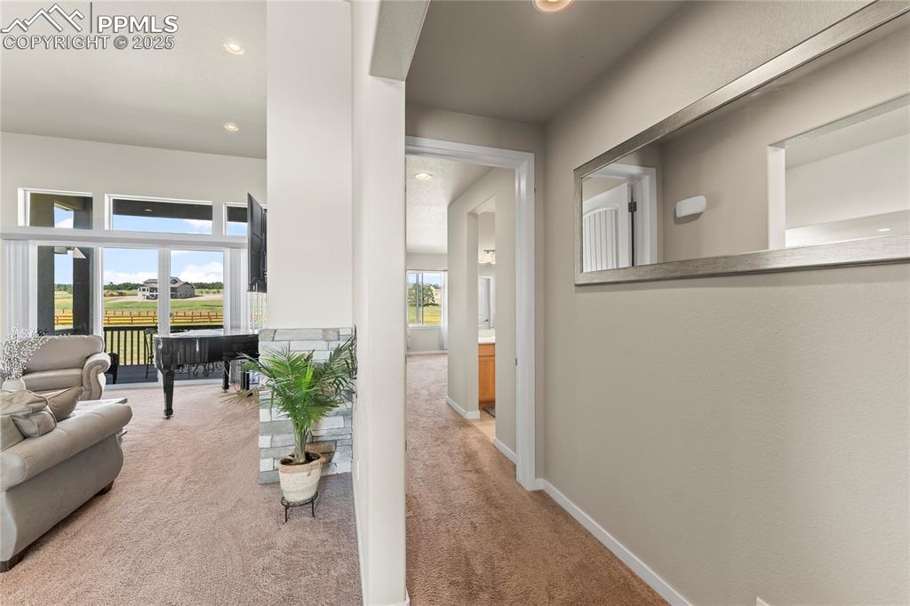 Image 22 of 50: Corridor with carpet flooring and recessed lighting