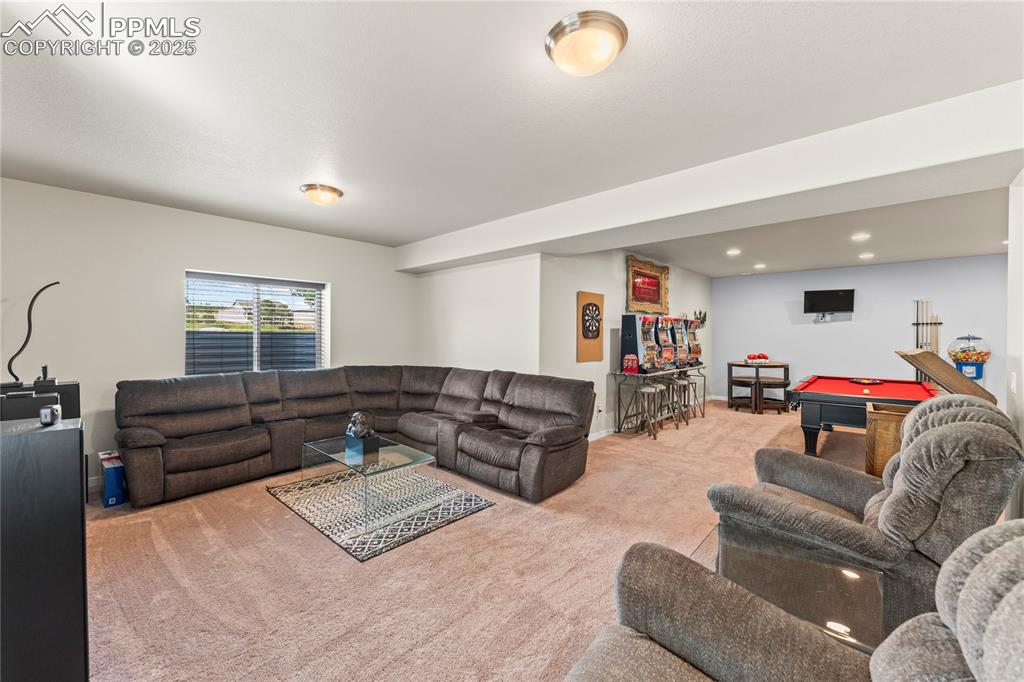 Image 41 of 50: Carpeted living area with billiards and recessed lighting