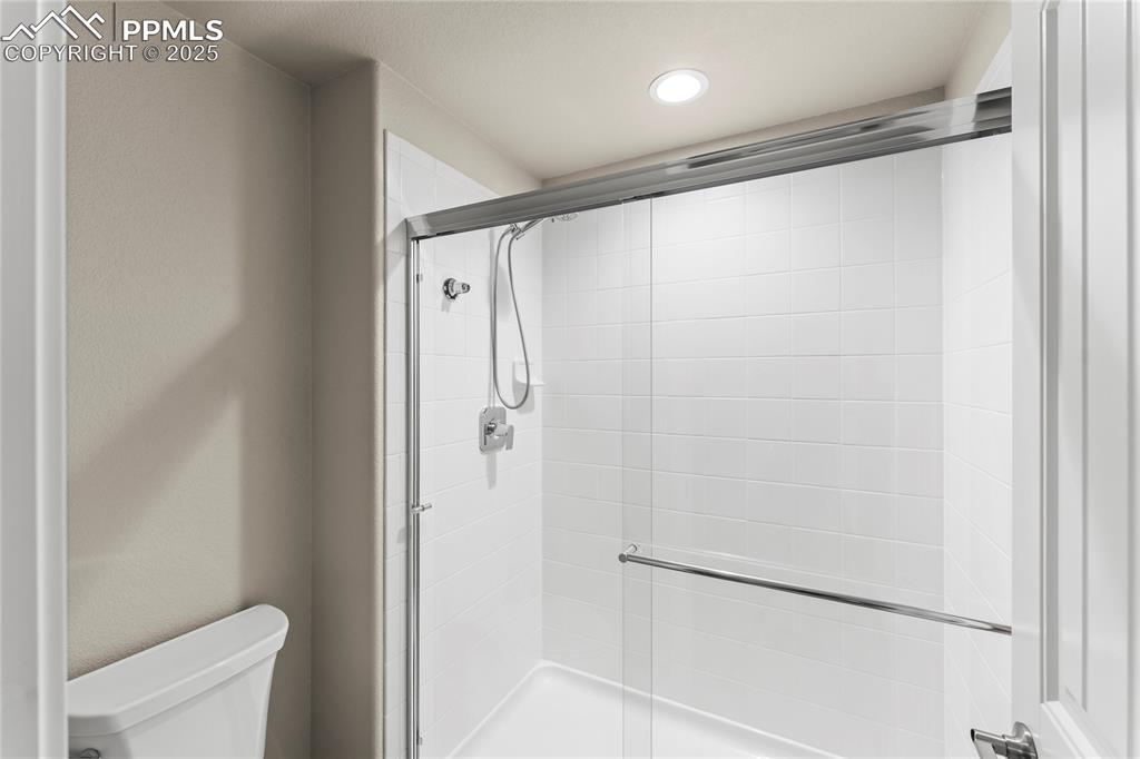 Image 46 of 50: Full bathroom featuring a shower stall and recessed lighting