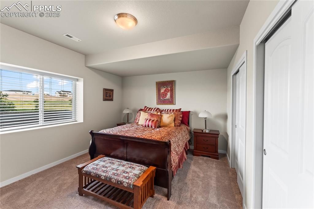 Image 47 of 50: Bedroom with carpet and baseboards
