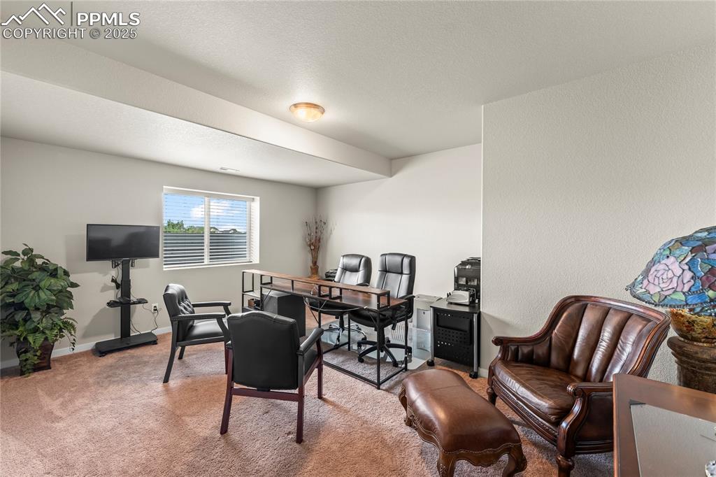 Image 49 of 50: Office area with carpet and baseboards