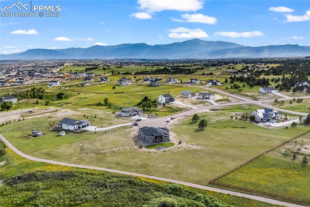 Image 5 of 50: Aerial view of residential area with a mountain backdrop