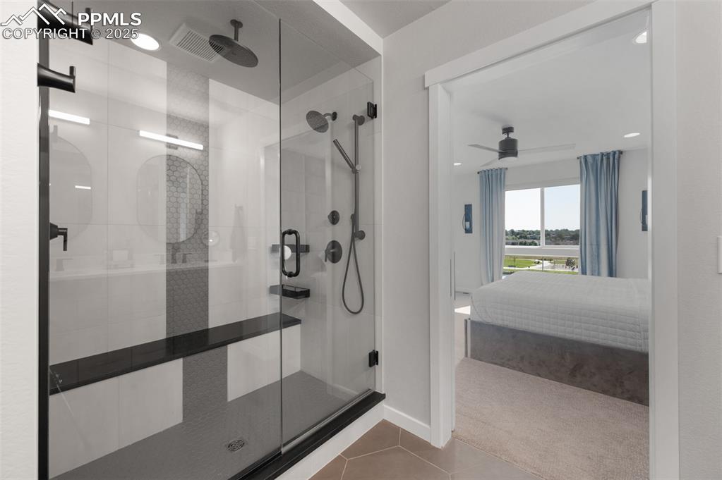 Image 13 of 27: oversized shower features a three-piece shower head system, delivering a sp