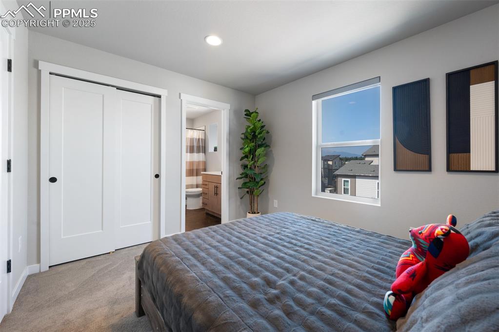 Image 14 of 27: Second bedroom suite with breathtaking Pikes Peak views and its own private