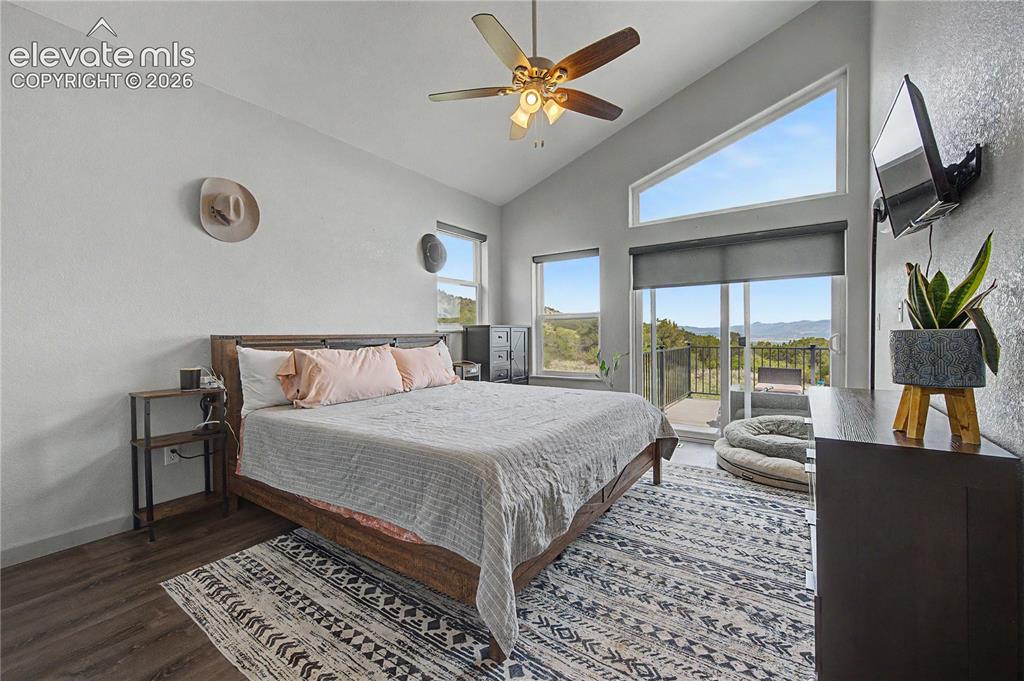 Image 18 of 41: The primary bedroom also has a sliding door to privately access the deck.