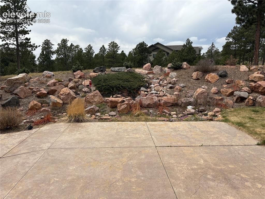 Image 11 of 44: Water Feature on berm from back patio
