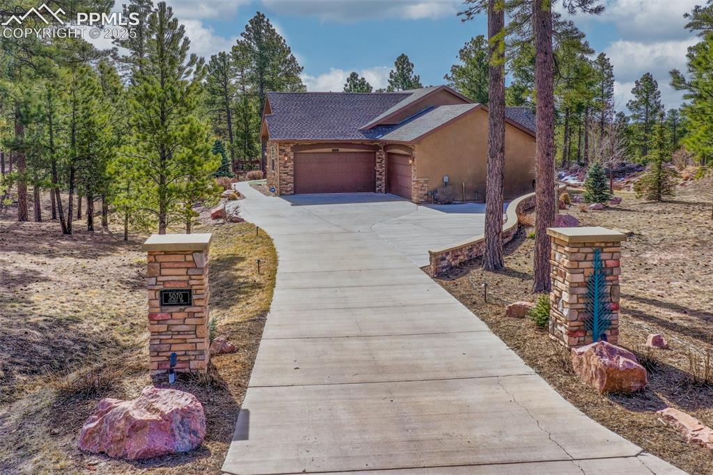 Image 2 of 44: View of front of house featuring the four car garage