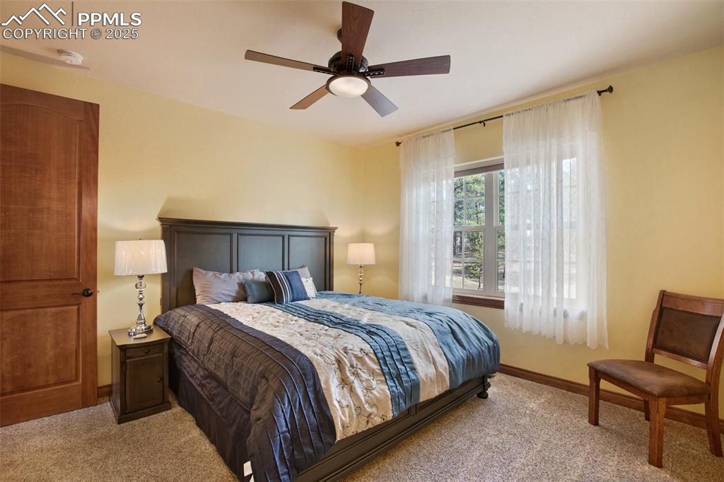 Image 26 of 48: Bedroom featuring baseboards, carpet, and a ceiling fan