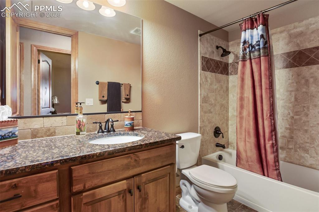 Image 30 of 44: Full bathroom in lower level located across from bedroom