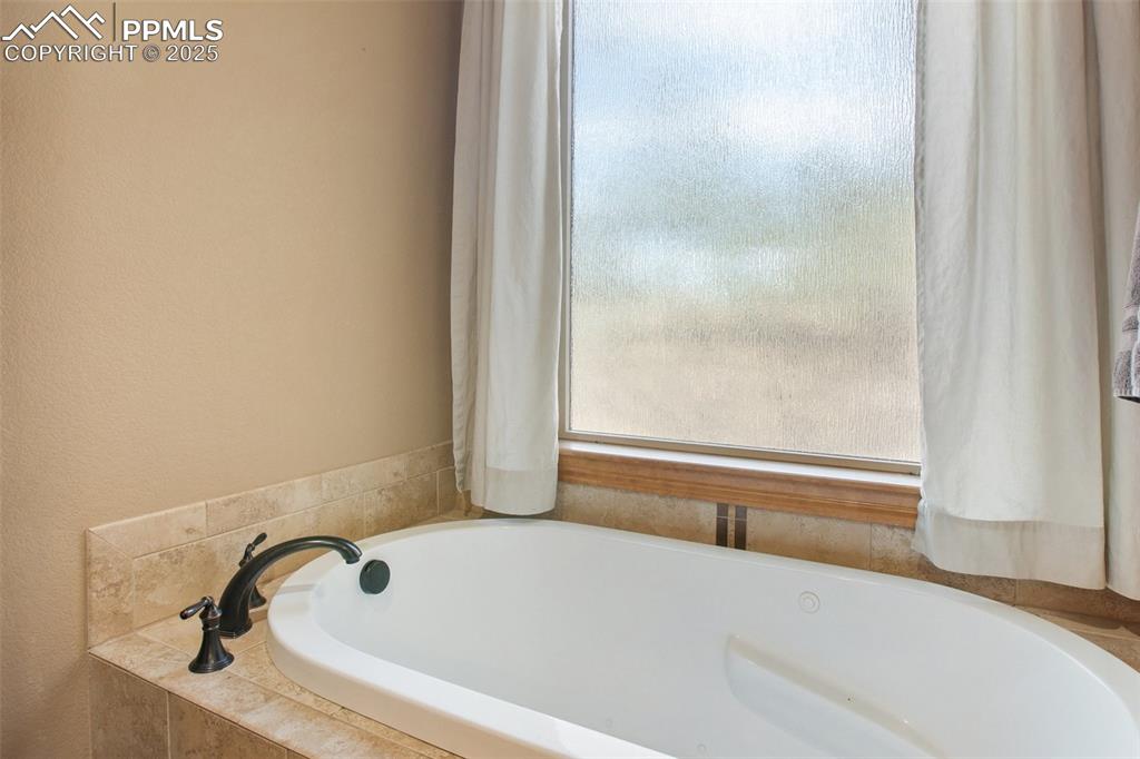 Image 33 of 48: Full bathroom with a garden tub