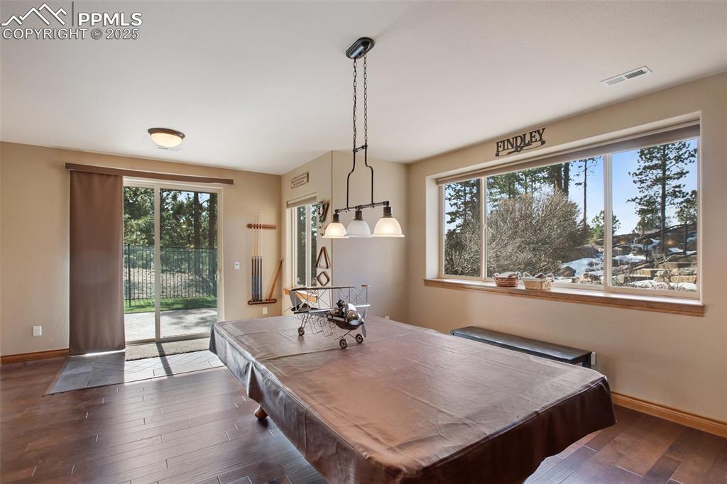 Image 34 of 48: Recreation room with visible vents, billiards, baseboards, and dark wood-st