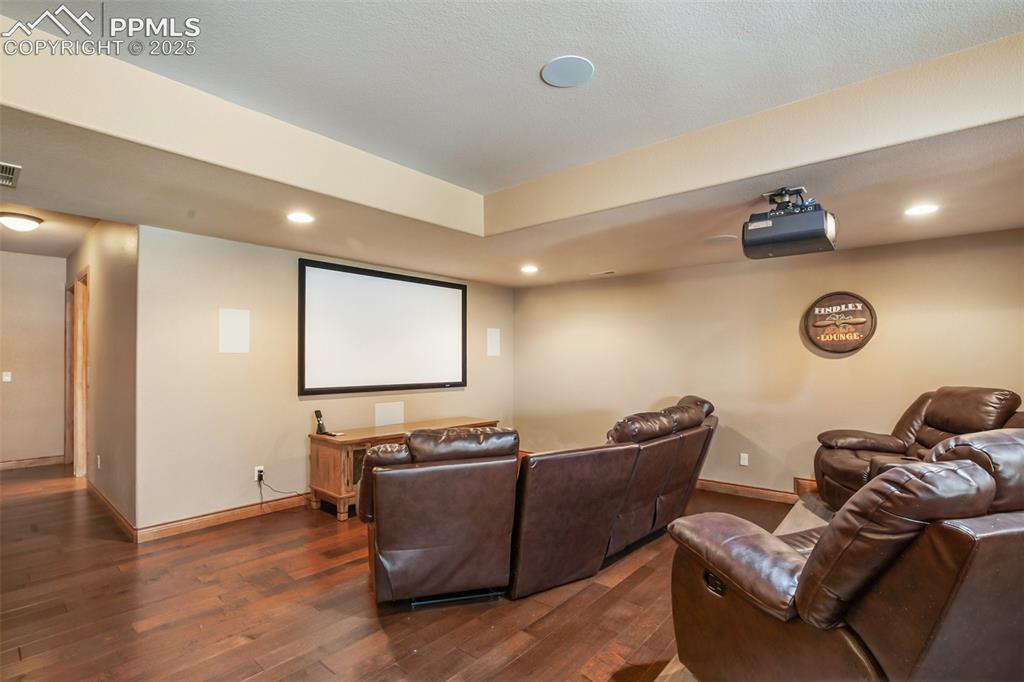 Image 34 of 44: Cinema room featuring all audio, projector and sitting