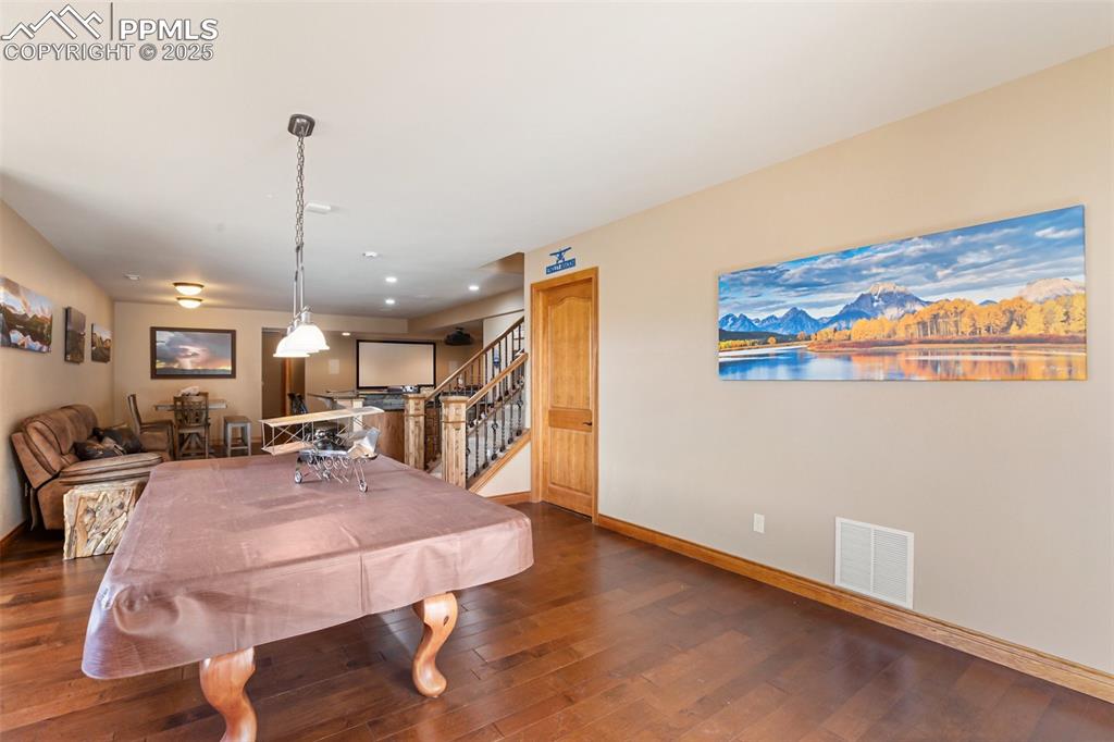 Image 35 of 48: Rec room with visible vents, baseboards, recessed lighting, dark wood-style