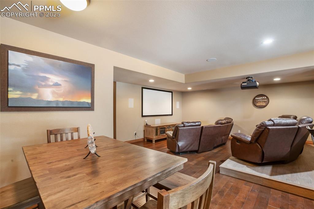 Image 37 of 48: Dining space with recessed lighting and dark wood finished floors