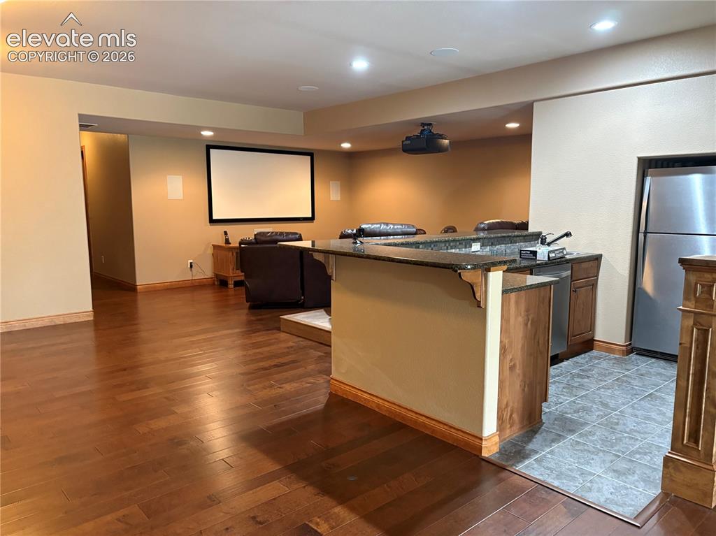 Image 39 of 44: Lower level kitchenette with stainless steel dishwasher and refrigerator