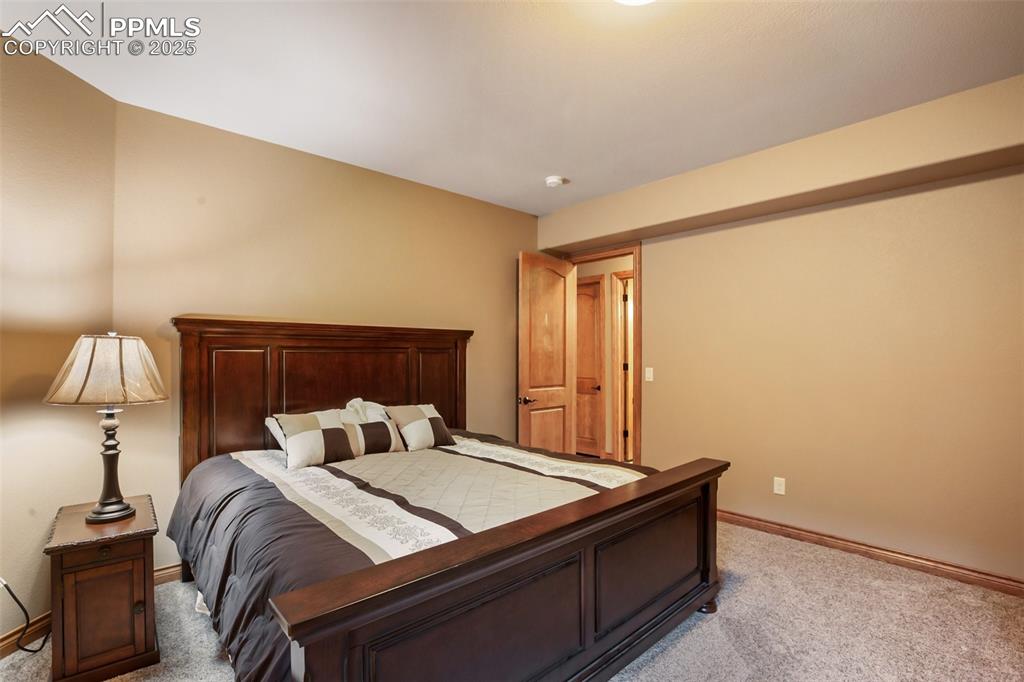 Image 43 of 48: Bedroom featuring light colored carpet and baseboards