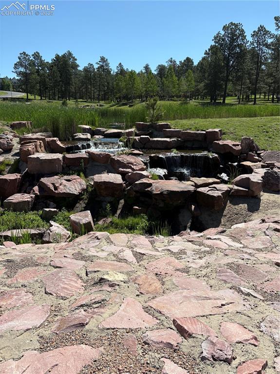 Image 44 of 44: Peaceful waterfall near the lodge in the Cathedral pines community