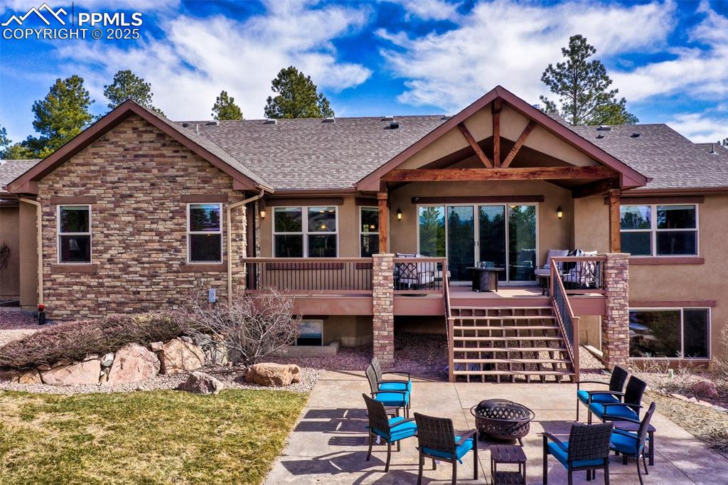 Image 6 of 48: Back of house with stairs, a patio, a fire pit, and roof with shingles