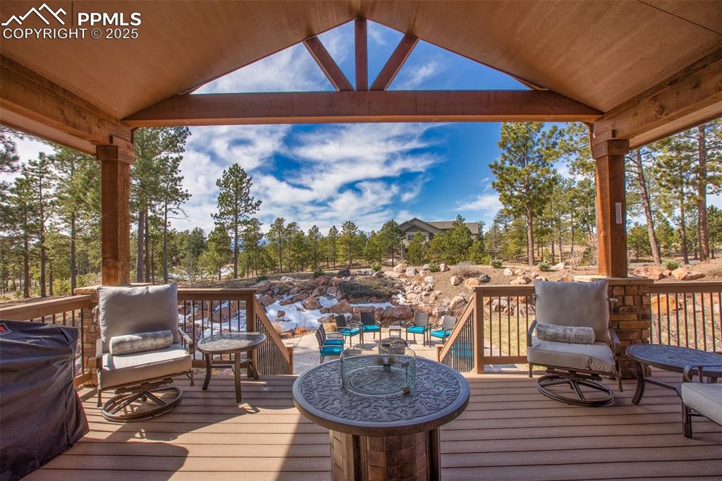 Image 9 of 48: Wooden terrace featuring an outdoor hangout area