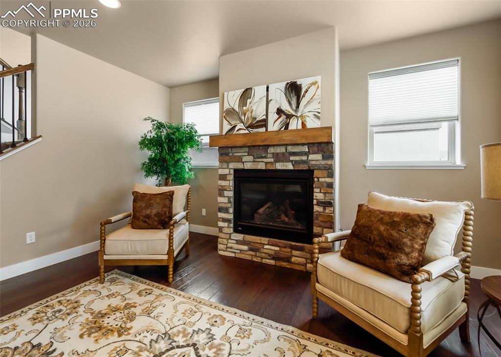 Image 10 of 50: Stone-faced fireplace with a substantial wood mantel