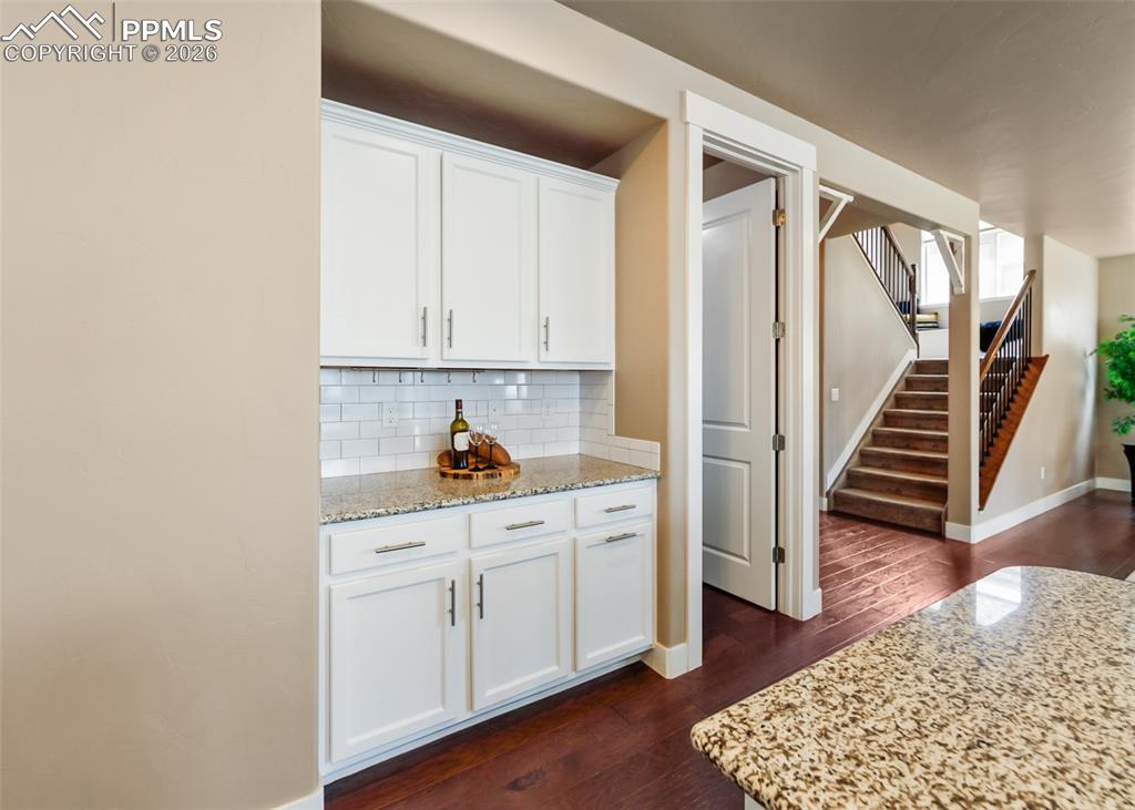 Image 17 of 50: Built-in cabinetry with a light-toned countertop and subway tile backsplash