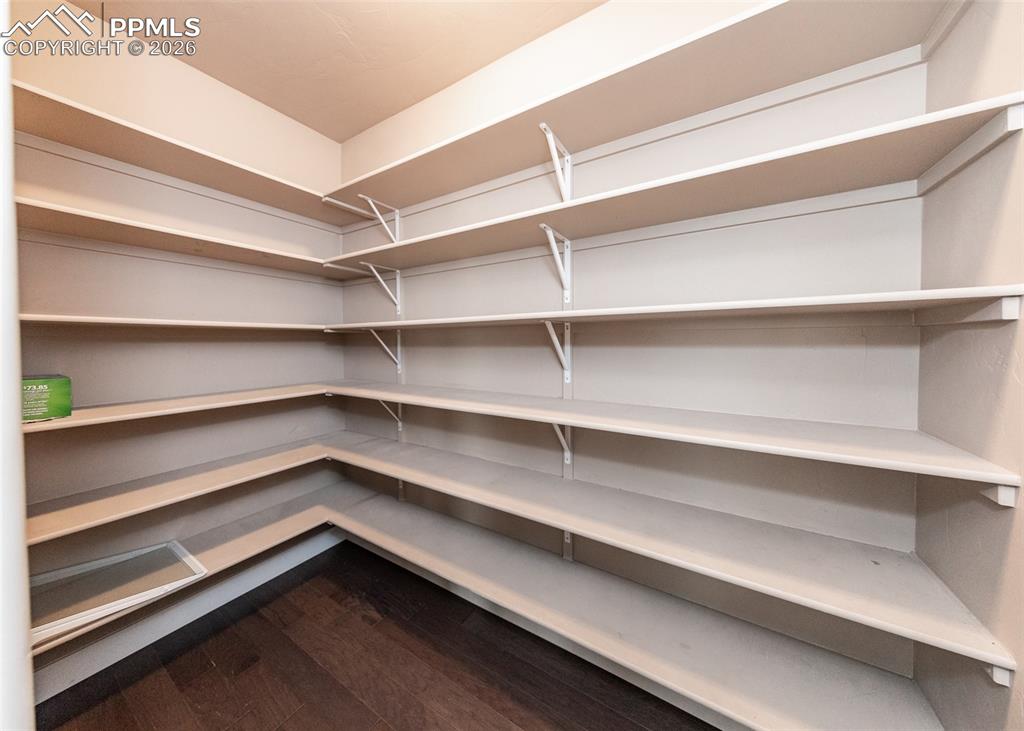 Image 18 of 50: Spacious walk-in pantry featuring abundant built-in shelving, durable const