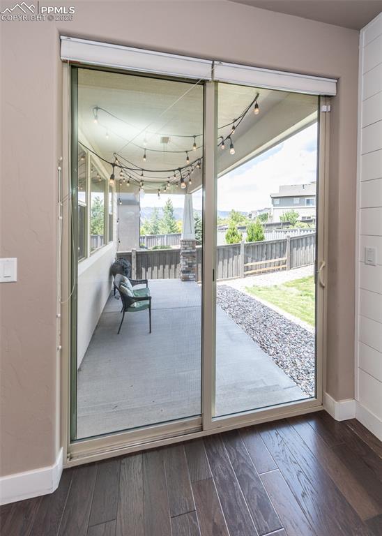 Image 21 of 50: Sliding glass door opening to a concrete patio